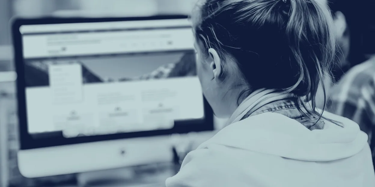 Person sitting at a computer using the Washington Department of Revenue website.