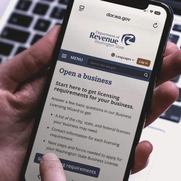 A mobile phone showing the Washington Department of Revenue website.