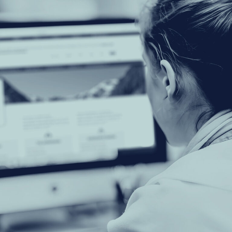 Person sitting a computer using the Washington Department of Revenue website.