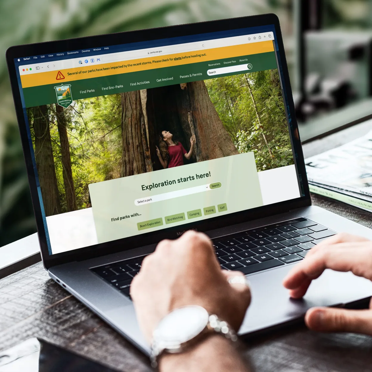 Person working on a laptop with the Washington State Parks website in a browser window.