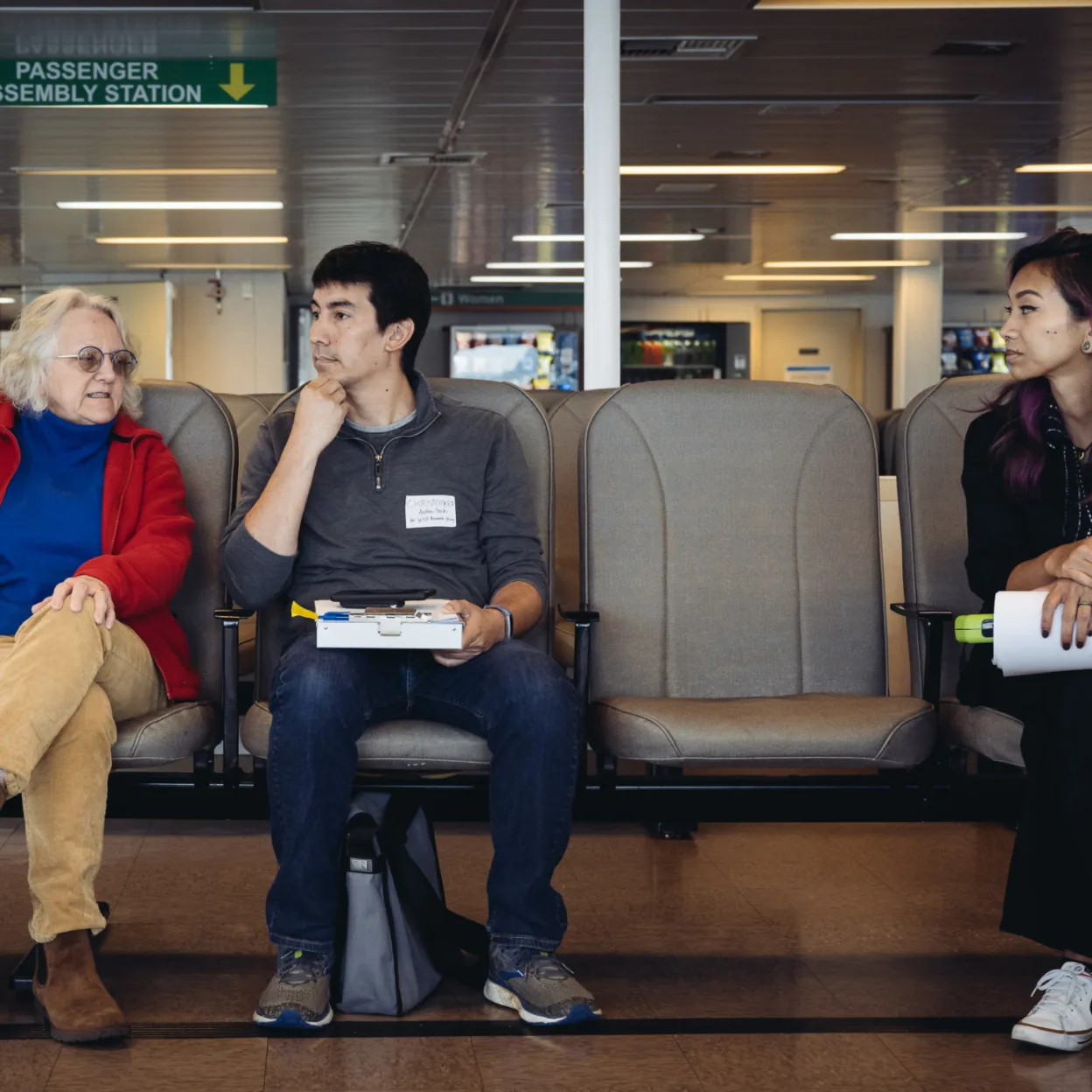 Two Anthro-Tech researchers conducting an Human-Centered Design interview with a passenger on a Washington State Ferry.