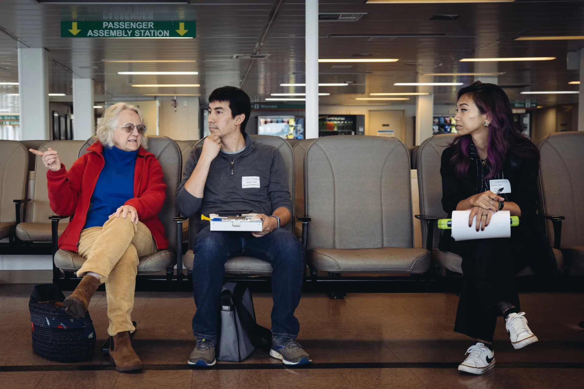 Two Anthro-Tech researchers conducting an Human-Centered Design interview with a passenger on a Washington State Ferry.