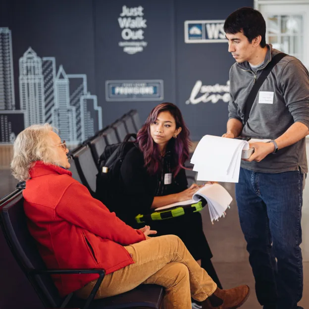 Anthro-Tech research team interviewing a woman at a Washington State Ferry terminal.