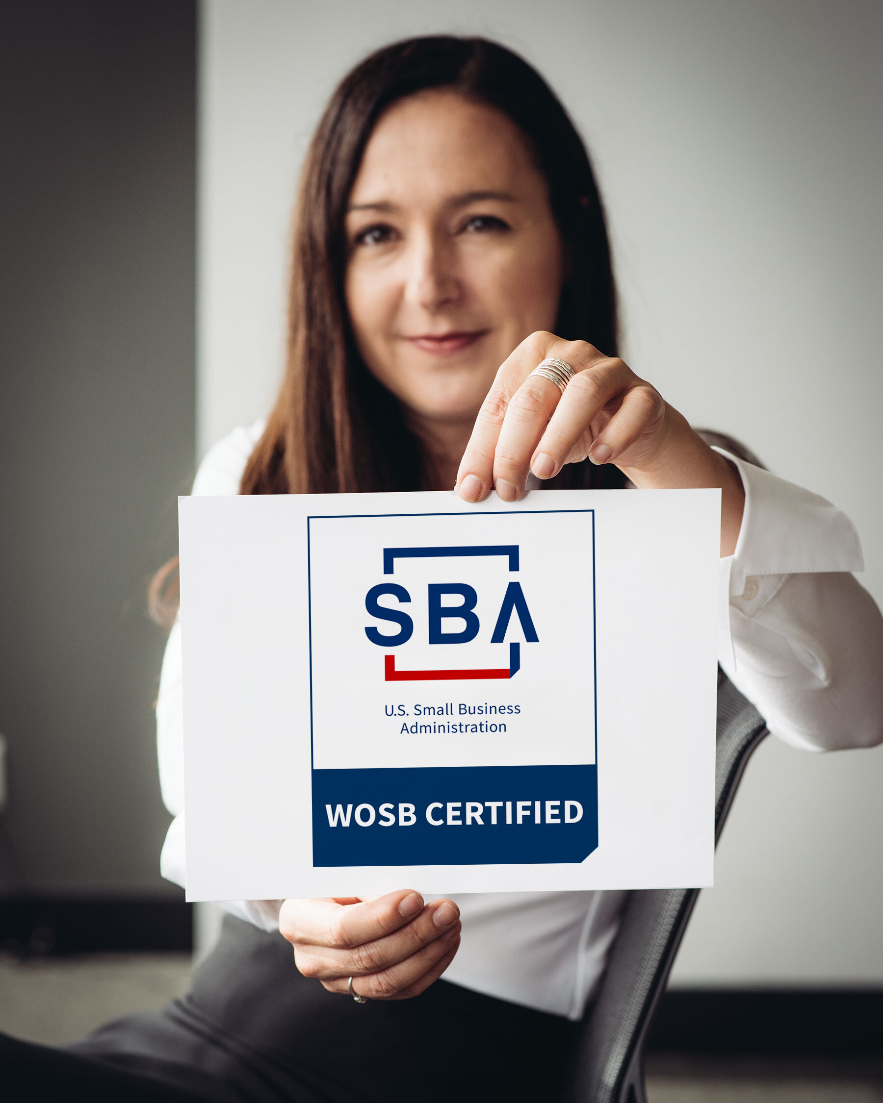 Anthro-Tech CEO, Suzanne Boyd, holding the SBA WOSB certificate.